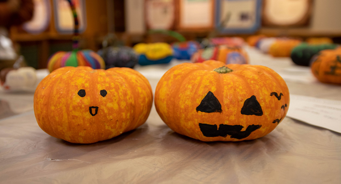 Two decorative pumpkins on a table.