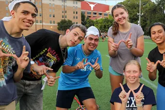 Six UT students pose on the grass