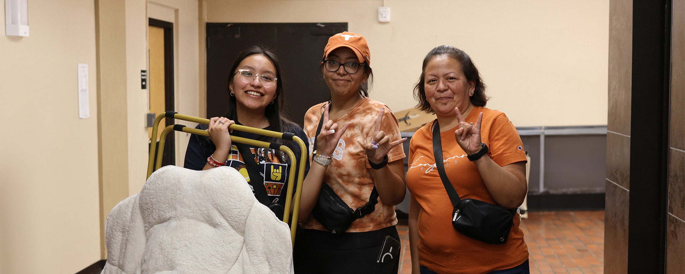 A resident and two others pose during fall departure from their hall