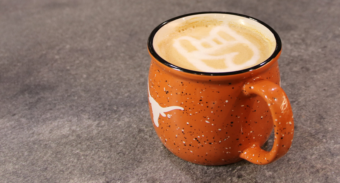 A cup of coffee with latte art of the Hook ‘em hand sign. Commented [AG4]: Alt Text: Team photo of the Moore- Hill Hall staff. Commented [AG5]: Alt Text: Team photo of the residence hall staff for the north area of campus.