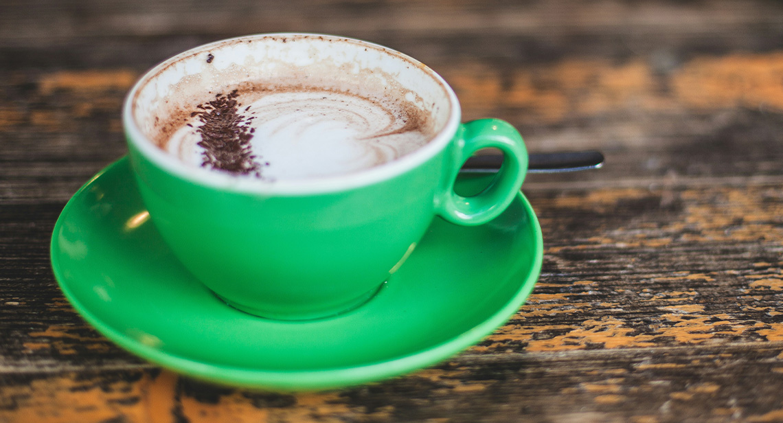 A cup of hot chocolate on a small plate