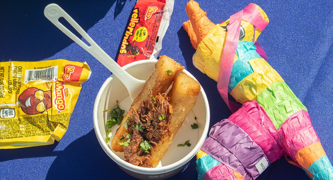 A view of a piñata placed next to various foods and candy