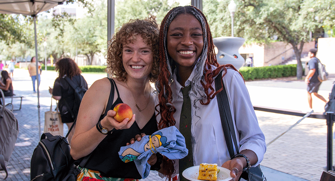 Two UT students pose together at the UT Farm Stand Market