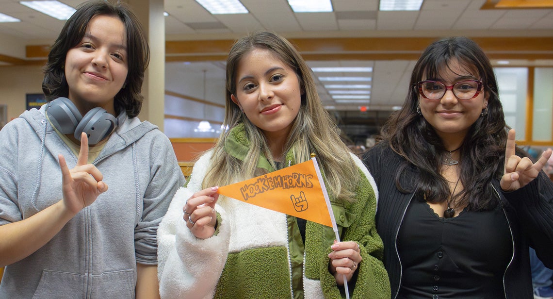 Three UT students pose together in Kins Dining