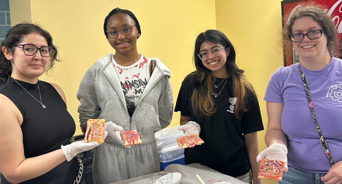 Four UT students displaying their homemade pastry made at a UHD Dietitian event