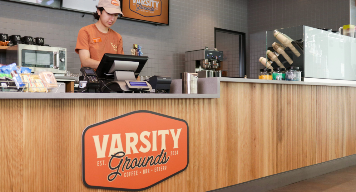 UT student dining worker at the service counter at Varsity Grounds.