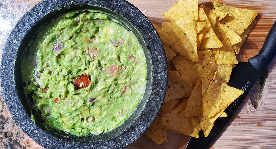 A bowl of guacamole and chips