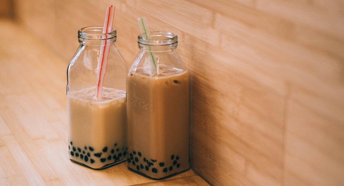 Two bottles of boba tea with straws