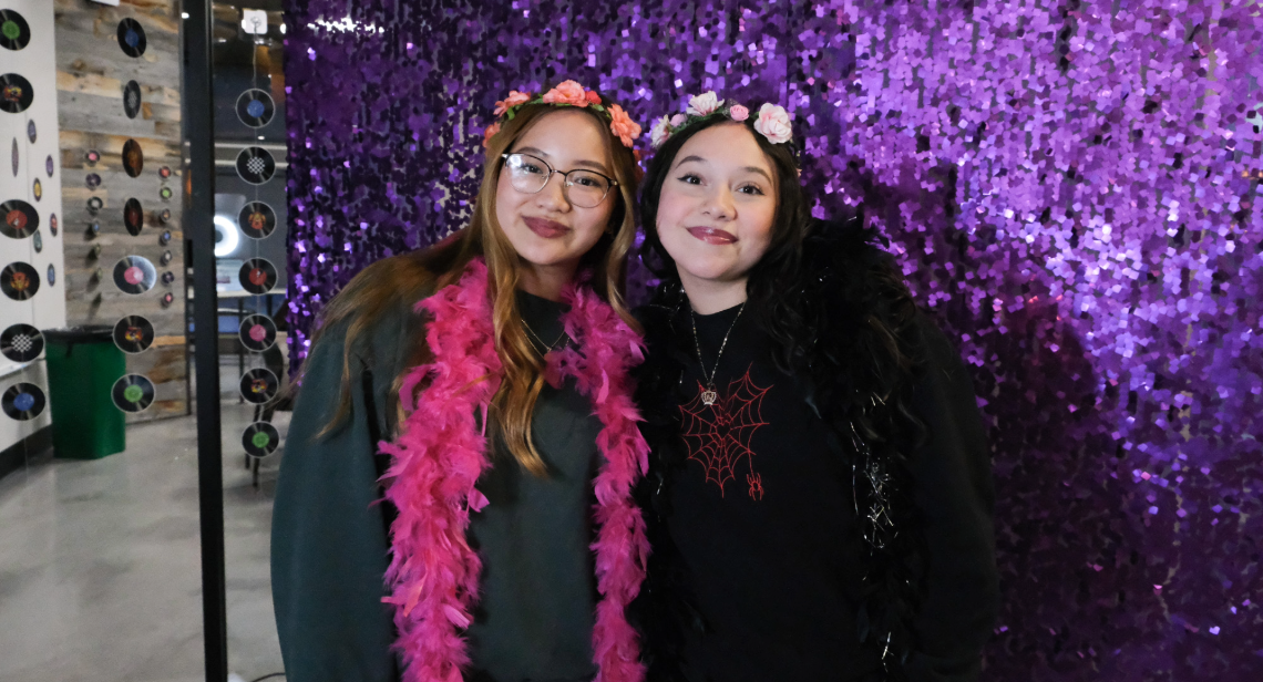 Two UT students pose at a photobooth