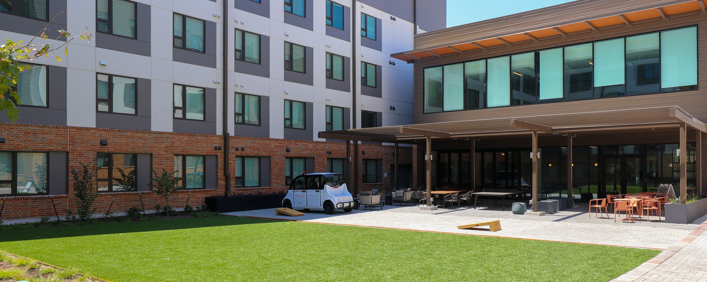  A view of the outdoor seating area at East Campus Graduate Apartment’s Commons Building