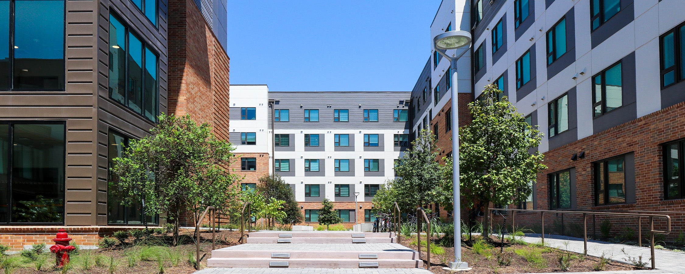 A view of the stair and ramp entry to East Campus Graduate Apartment’s Building A courtyard