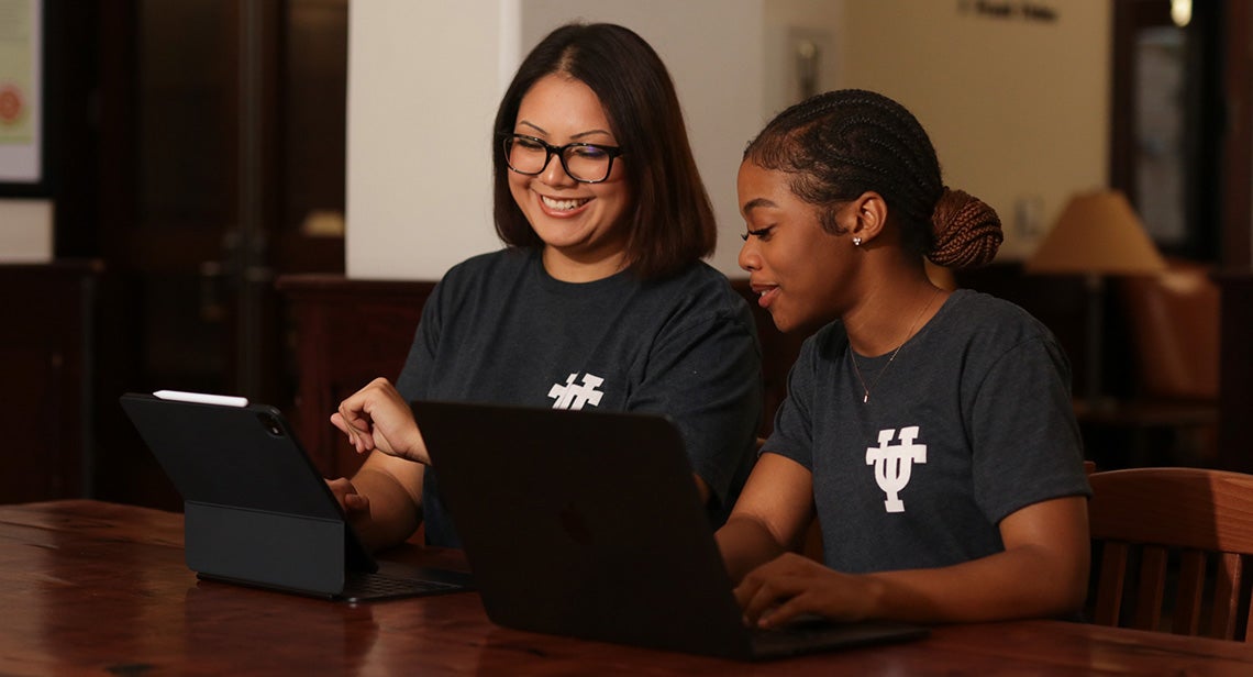 Two UT students study together in a residence hall study lounge