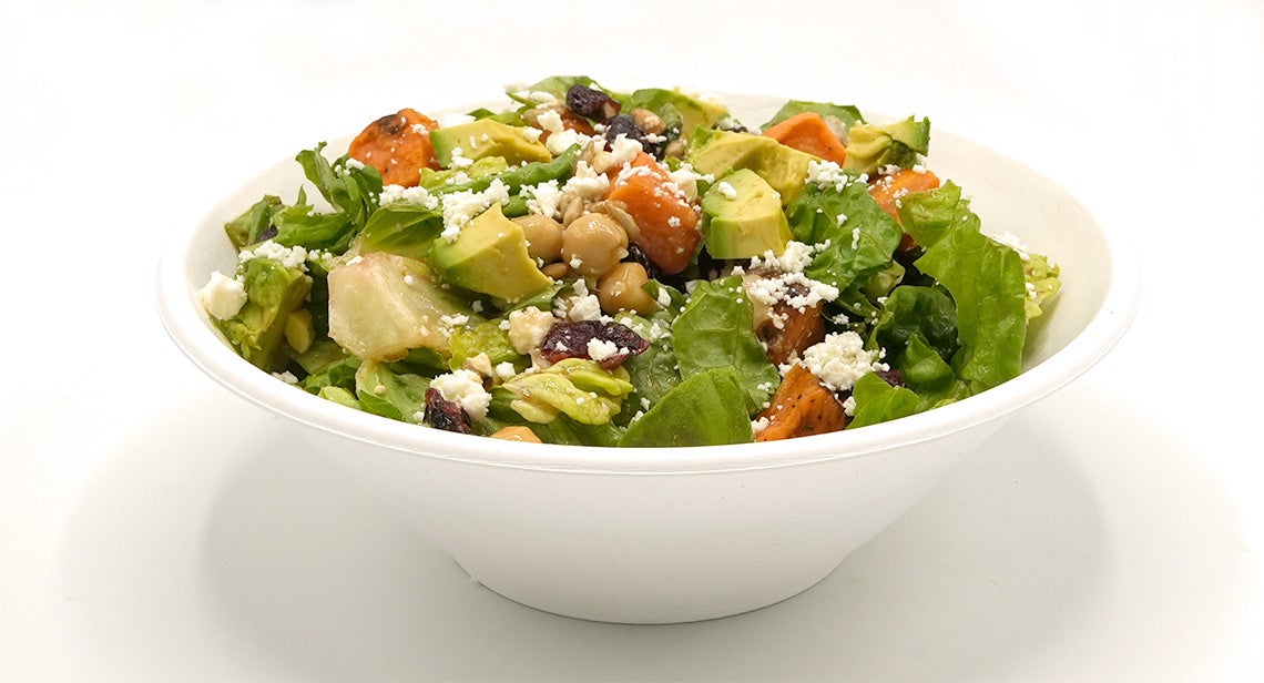 A close up of a salad that features sweet potato, avocado and chickpeas
