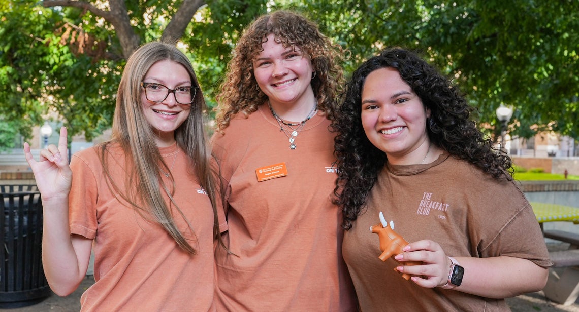 Three UT students pose together in the BRP Courtyard. 