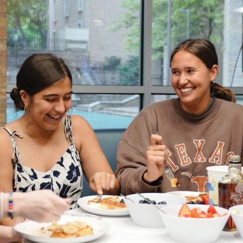 Two students at a dining table