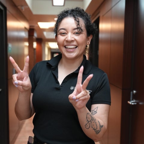 A student is making the victory sign with both hands