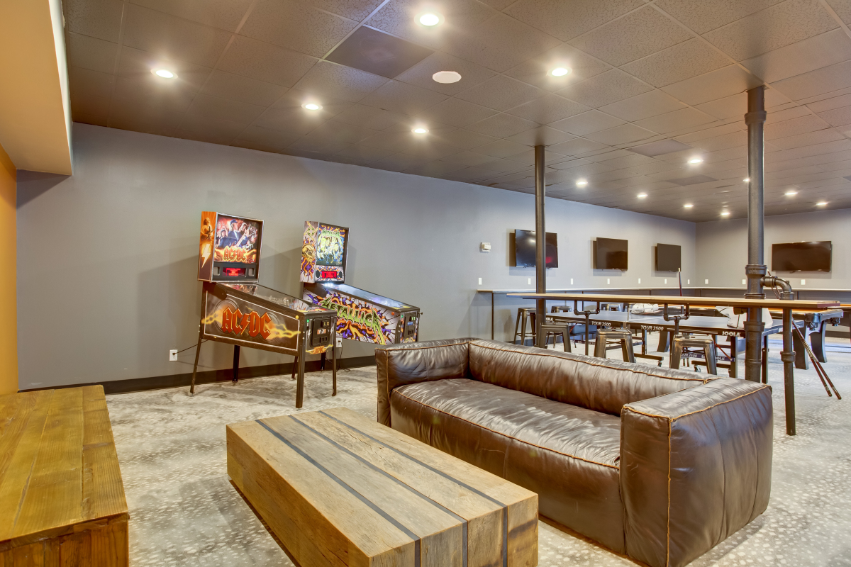 Dobie - Game room with couch and pinball machine