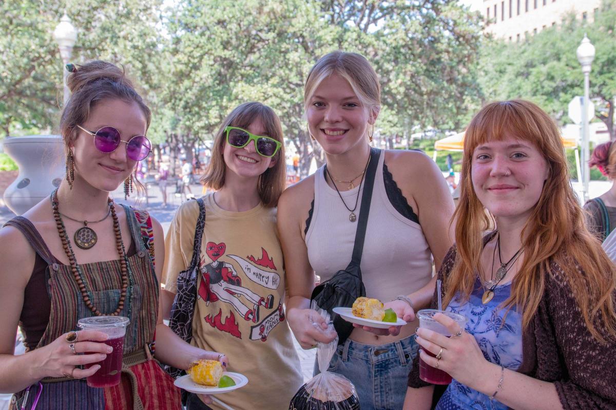 UT Farm Stand Market - four smiling students at market event