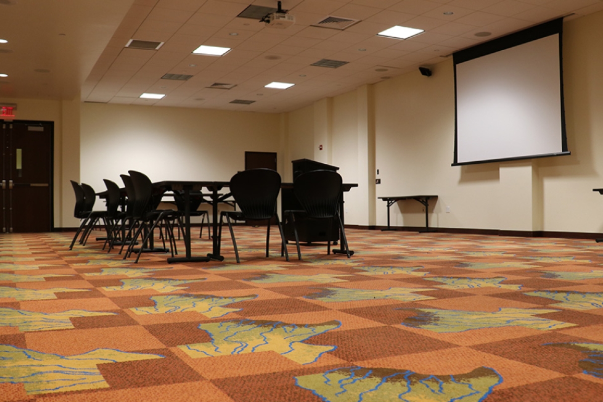 A conference table and chairs set up for a meeting in Duren Multipurpose Room.