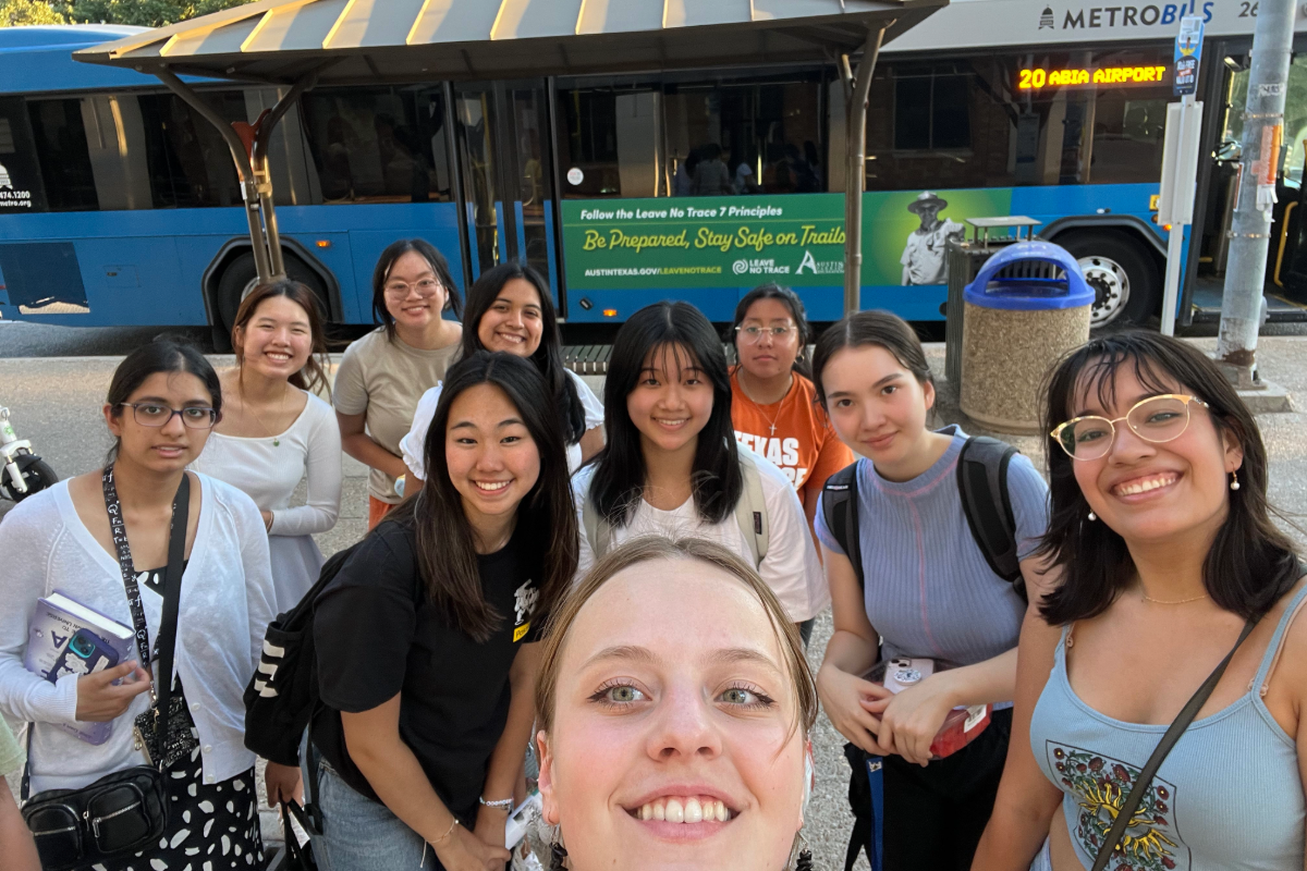 Group of LLC members outside a Metrobus UT bus stop