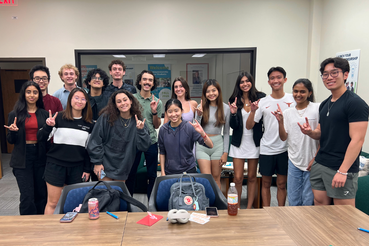 Group of LLC students posing with a Hook ‘em hand sign