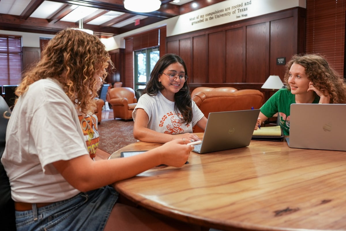 Students in Duren Three UT students wearing UT shirts study in Duren Hall.
