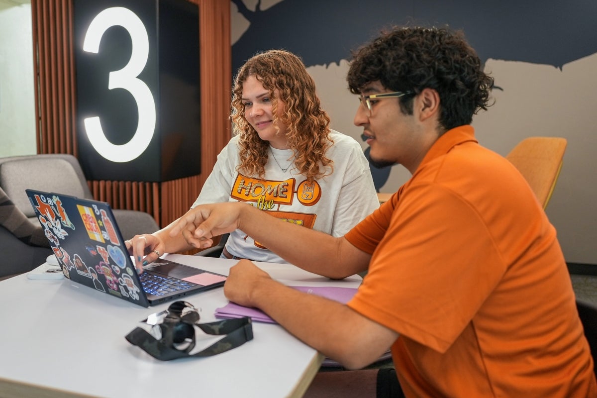 Students at Kinsolving Two UT students wearing UT shirts study in Kinsolving Hall’s common room.