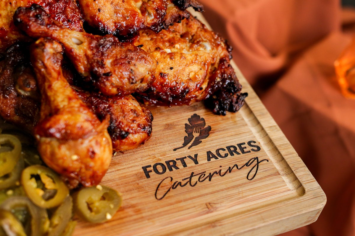 Barbecue grilled chicken with jalapenos on a Forty Acres Catering cutting board