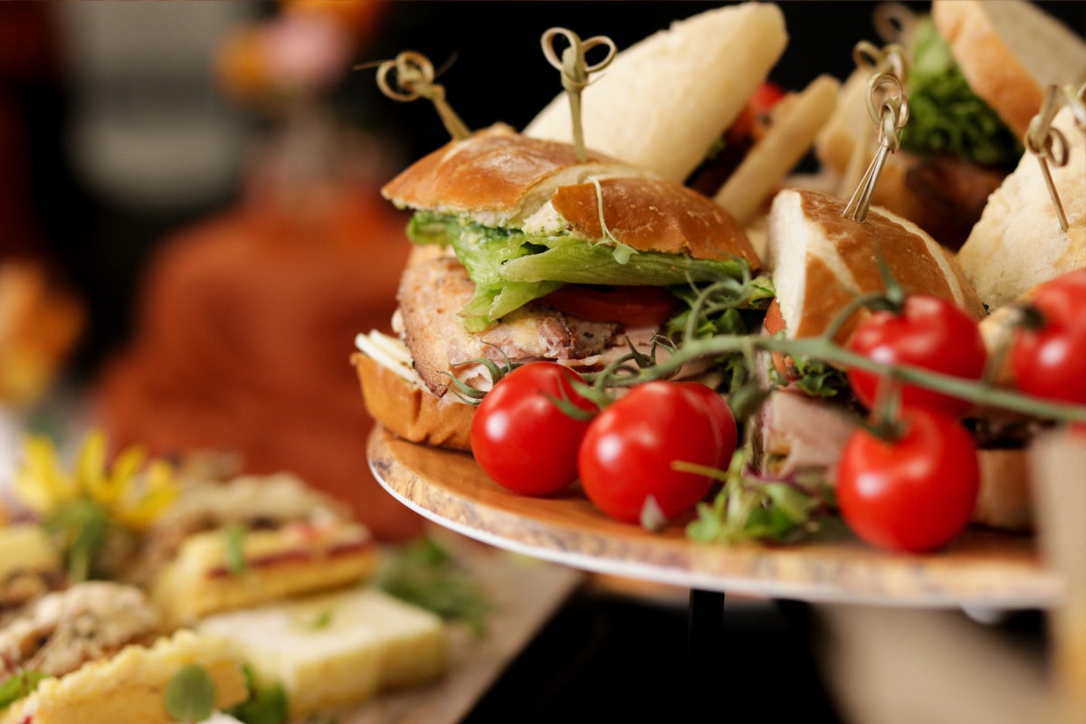 Sandwiches and grape tomatoes on the vine served on a platter