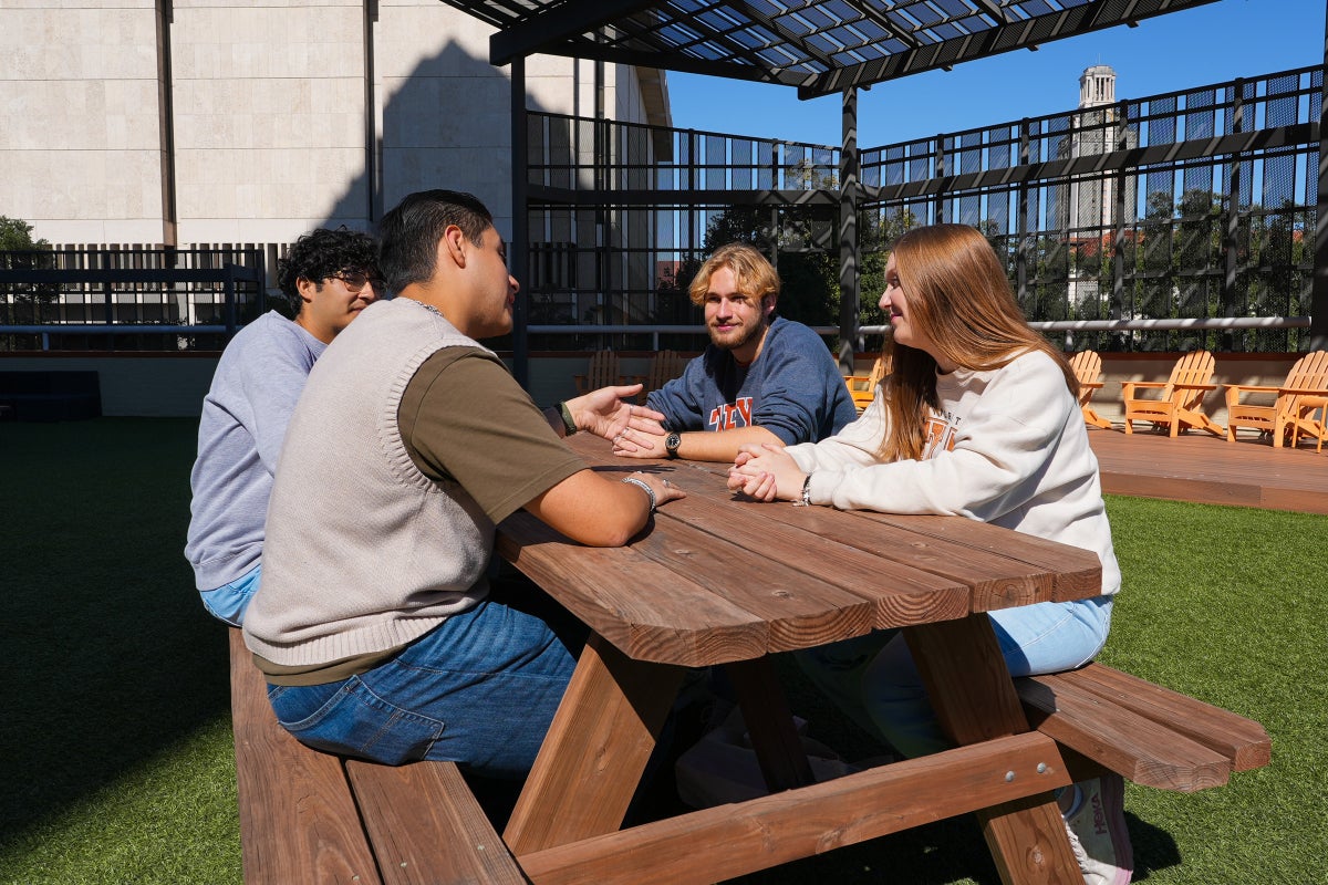 A group of UT students converse on the Dobie Twenty21's rooftop terrace.