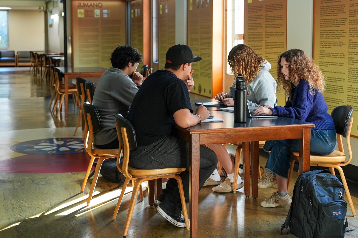 A group of UT students study together in a Jester West hallway. 