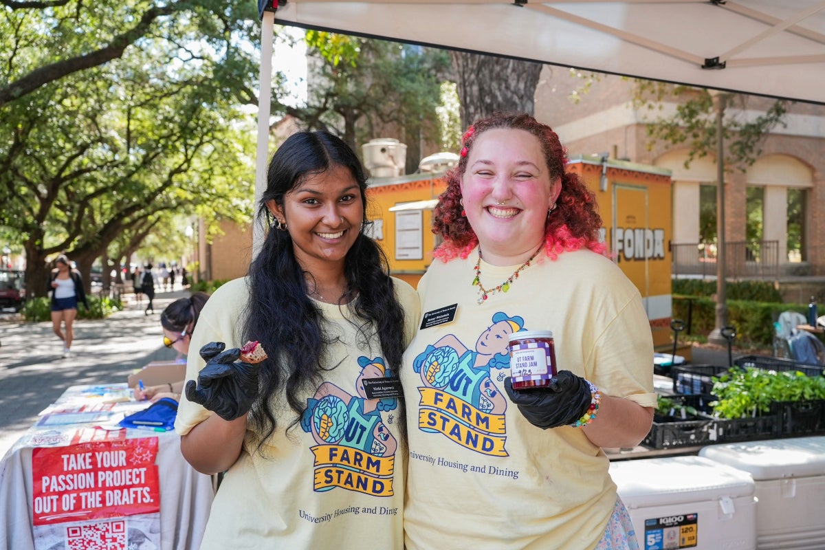 Two UT students pose while they hold samples of the jams at a UT Farm Stand market