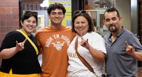 A UT student and three family members pose together in Jester Center at Mooov-In.