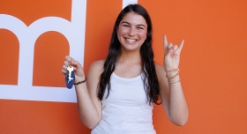 A UT student poses while holding keys at Mooov-In