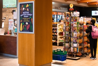 Interior shot of students shopping at Kin’s Market, the convenience store inside Kinsolving Residence Hall