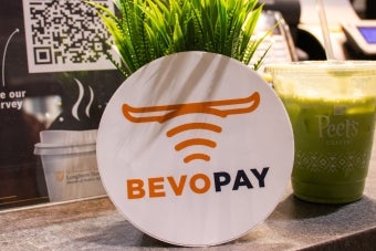 A Bevo Pay sticker and a Peet’s Coffee Iced Matcha Green Tea Latte displayed promotionally on the ordering counter at Littlefield Patio Cafe. 