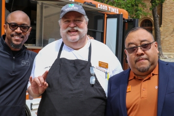 Three UHD employees posed in front of the 512 Brew Bus in the Honors Quad courtyard