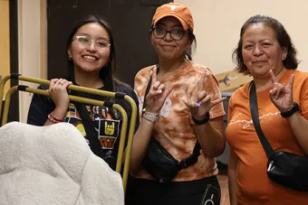 A resident and two others pose during fall departure from their hall
