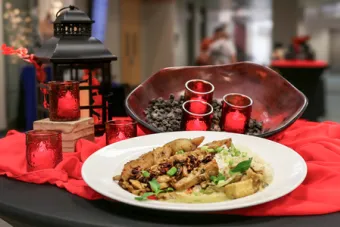 A plate of food prepared by Forty Acres Catering and decor on display at San Jacinto Hall