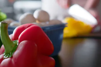 Bell peppers and a variety of other vegetables on a table.