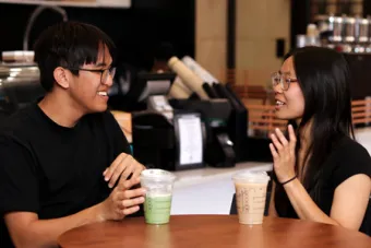 Two UT students converse over coffee at Prufrock