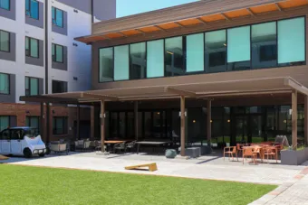 An outdoor seating area featured at the back of the Commons building at East Campus Graduate Apartments