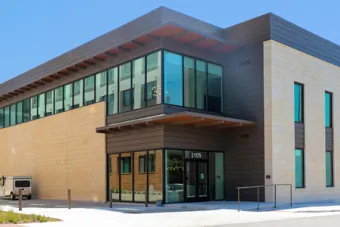 The Comal Street view of the Commons building at East Campus Graduate Apartments.