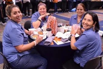 UT staff members dine at an event in the San Jacinto Multipurpose Room.