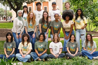 UT Farm Stand student volunteers and staff pose for a group photo while wearing UT Farm Stand shirts