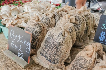 A close up of potting soil bags featuring the UT Farm Stand