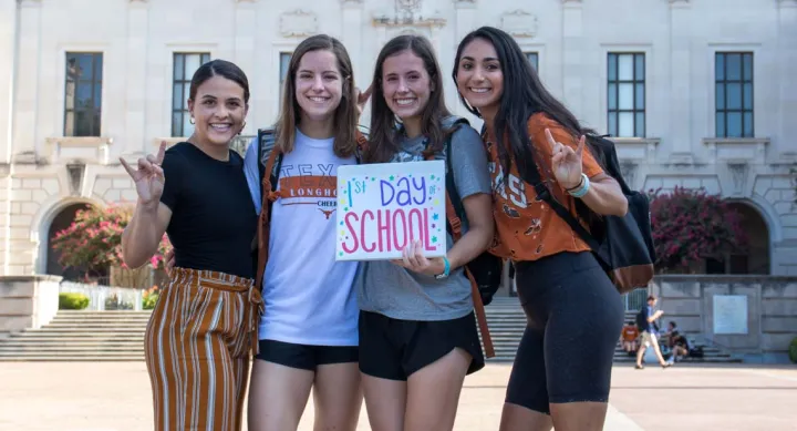 Students posing behind UT Tower