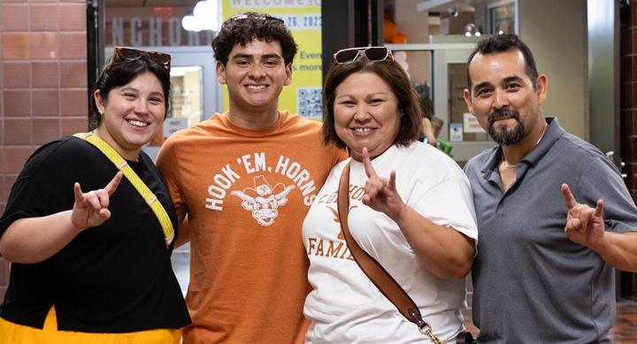 A UT student and three family members pose together in Jester Center at Mooov-In.