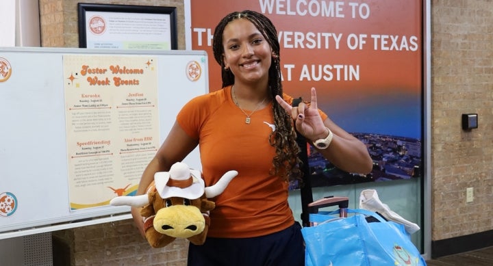 Alt text: A University of Texas at Austin student poses while moving into Jester.